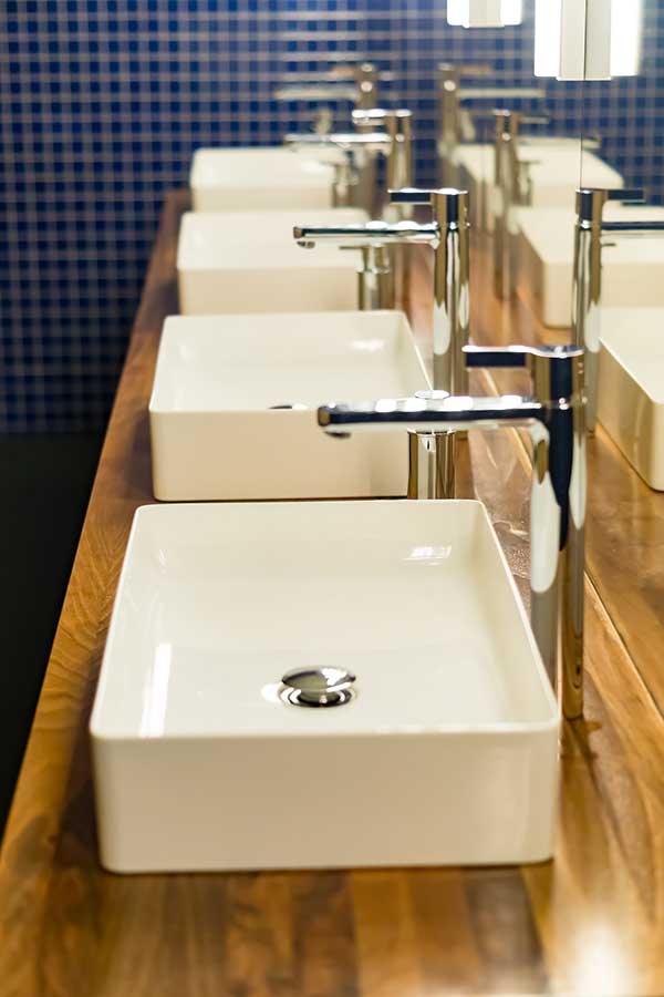 a line of sinks in a commercial building bathroom